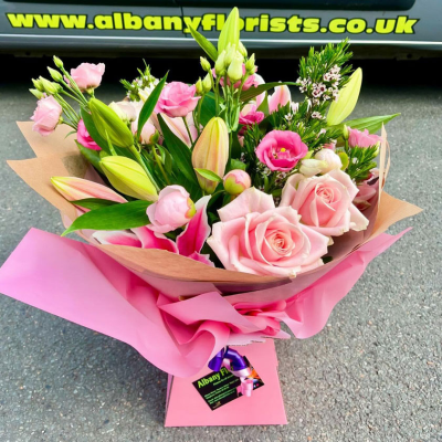 Pink Blush Lily Handtie - A gorgeous hand-tied bouquet filled with elegant pink lilies, blush roses and delicate lisianthus, beautifully wrapped by Albany Florists for maximum impact. Soft, romantic and perfect for making someone’s day extra special.