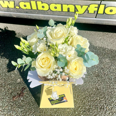 Classic Ivory Gift Bag - A fresh and elegant white rose arrangement presented in a stylish gift bag by Albany Florists for easy display. Simple, graceful and endlessly versatile.