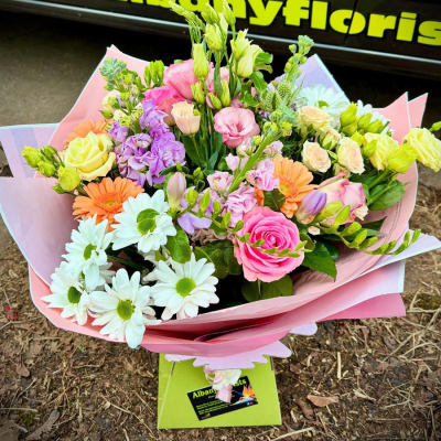 Cottage Blush - A soft pastel handtie inspired by traditional cottage gardens, featuring delicate seasonal flowers and fresh greenery carefully styled by Albany Florists.