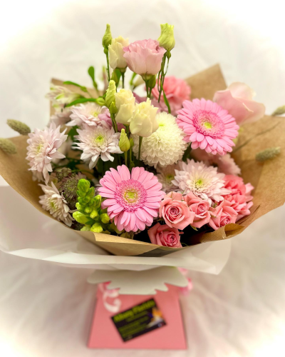 Pretty in Pink - A charming hand-tied bouquet in soft blush pink, ivory, and pastel tones, beautifully wrapped for an elegant presentation. Designed with a delightful mix of textures and delicate blooms, this arrangement radiates warmth, sweetness, and gentle sophistication. Perfect for birthdays, new baby celebrations, thank-you gifts, anniversaries, or simply letting someone know they are loved, it brings a fresh and uplifting touch to any occasion.