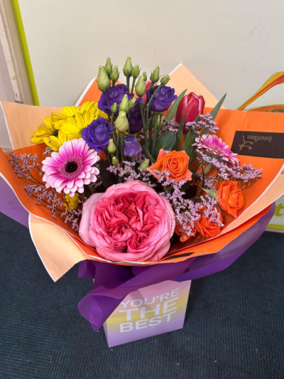 Summer Splash - A joyful and contemporary bouquet bursting with vivid pink, purple, orange, yellow, and red tones. Expertly arranged with a playful blend of colours, textures, and elegant accents, this design radiates happiness, appreciation, and celebration. Beautifully presented in stylish wrapping, it is the perfect gift for birthdays, congratulations, thank-you messages, achievements, or any occasion that calls for a bright and memorable gesture.