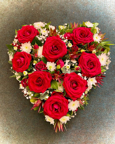 Red Rose Heart - A beautiful heart-shaped funeral tribute created to express deep love, admiration, and everlasting remembrance. Designed in rich crimson tones complemented by soft accents and natural greenery, this elegant arrangement symbolises affection, respect, and the enduring connection shared with a loved one. Thoughtfully crafted as a meaningful final farewell, it offers comfort to grieving family and friends while honouring a life that will remain forever in their hearts.