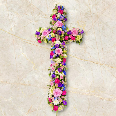 Cross - A beautiful cross-shaped funeral tribute designed to express faith, hope, and everlasting remembrance. Arranged in a delicate blend of soft pastel tones with touches of vibrant colour and fresh greenery, this elegant design offers a heartfelt symbol of comfort and spiritual reflection. Thoughtfully crafted to honour a cherished life, it provides a meaningful expression of sympathy and a loving farewell, bringing peace and comfort to family and friends during a difficult time.